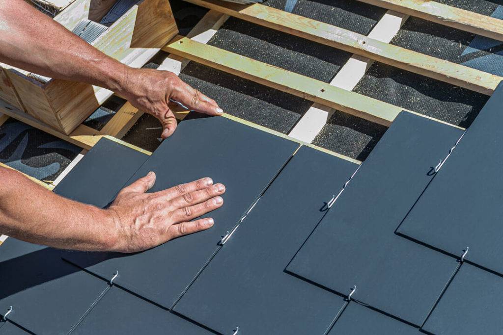slate roof being installed